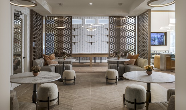 a room with several tables and chairs 
