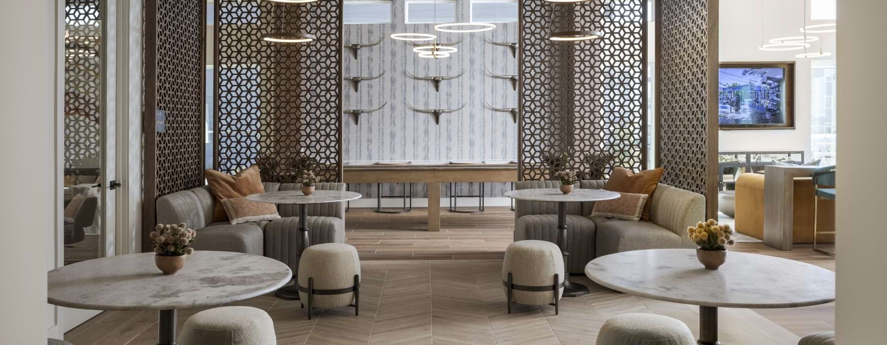 a room with several tables and chairs 