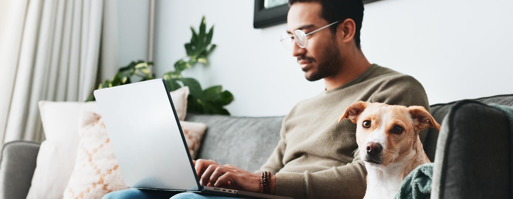 a person sitting on a couch with a dog